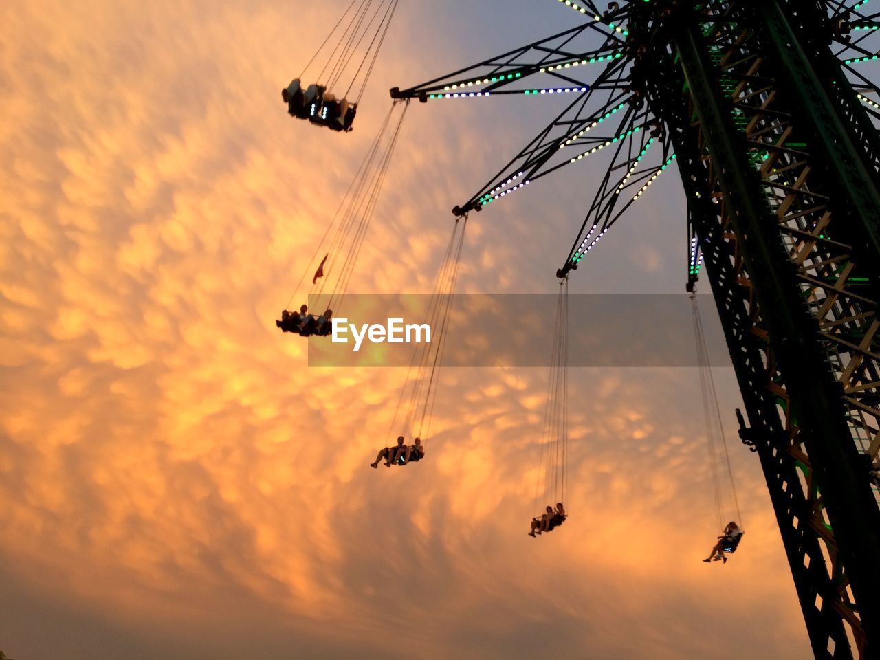 LOW ANGLE VIEW OF SILHOUETTE CRANE AGAINST SKY DURING SUNSET