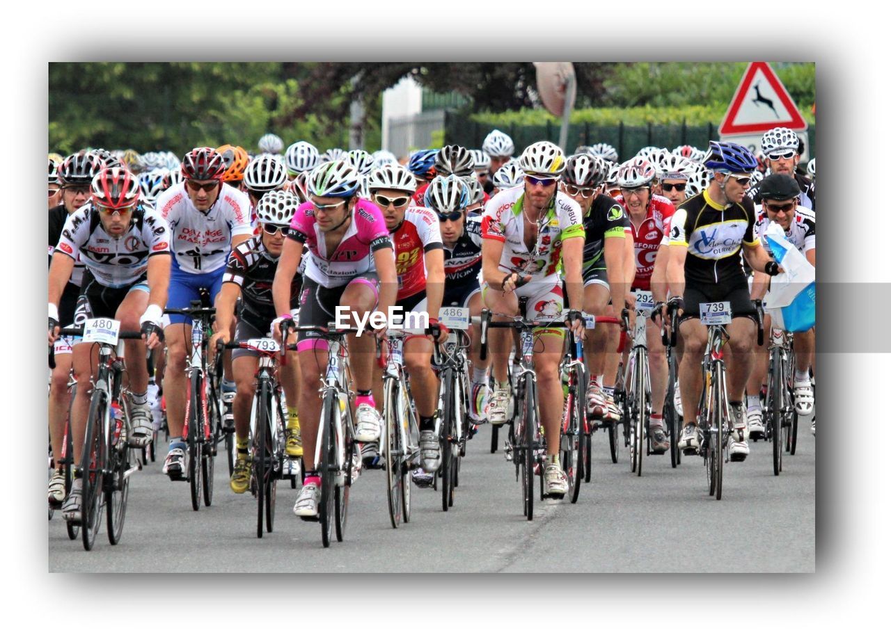 GROUP OF PEOPLE IN FRONT OF A BICYCLE