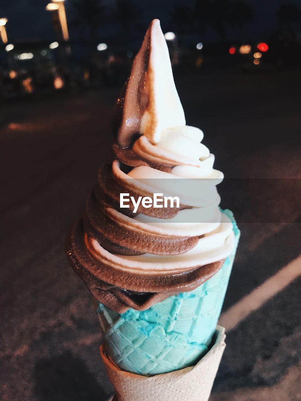 CLOSE-UP OF ICE CREAM CONE ON CAKE