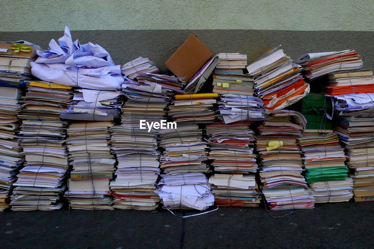 Stack of books and field against wall