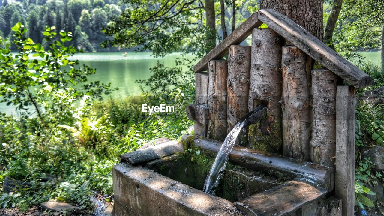 Water flowing from fountain at lakeshore