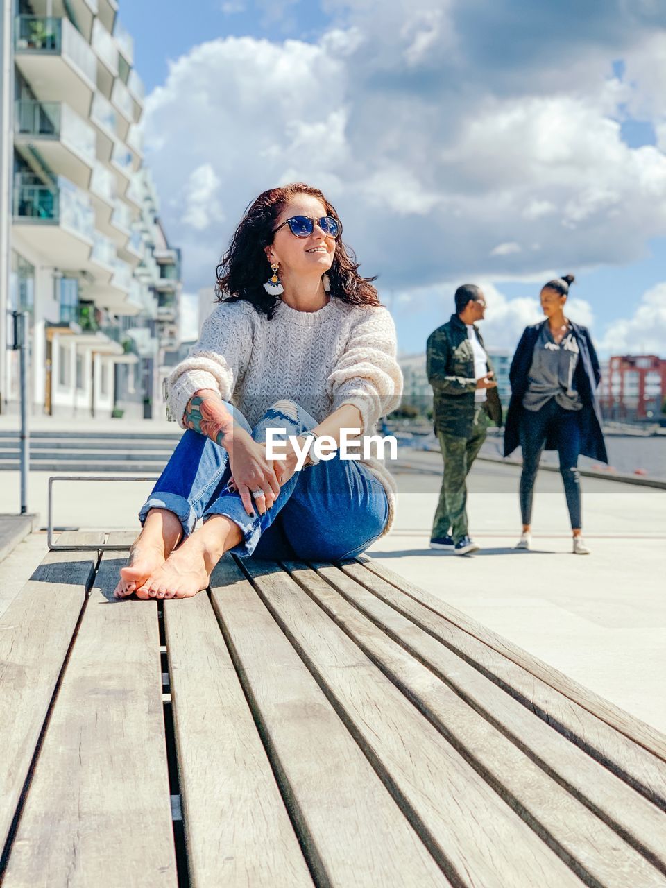 Full length of young woman sitting outdoors