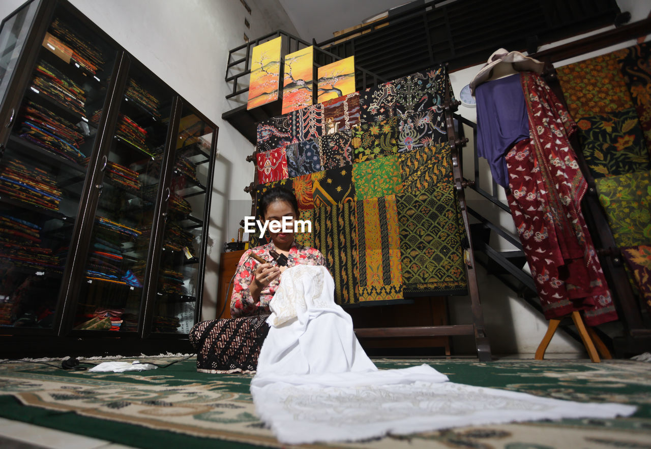 Low angle view of woman working in textile workshop