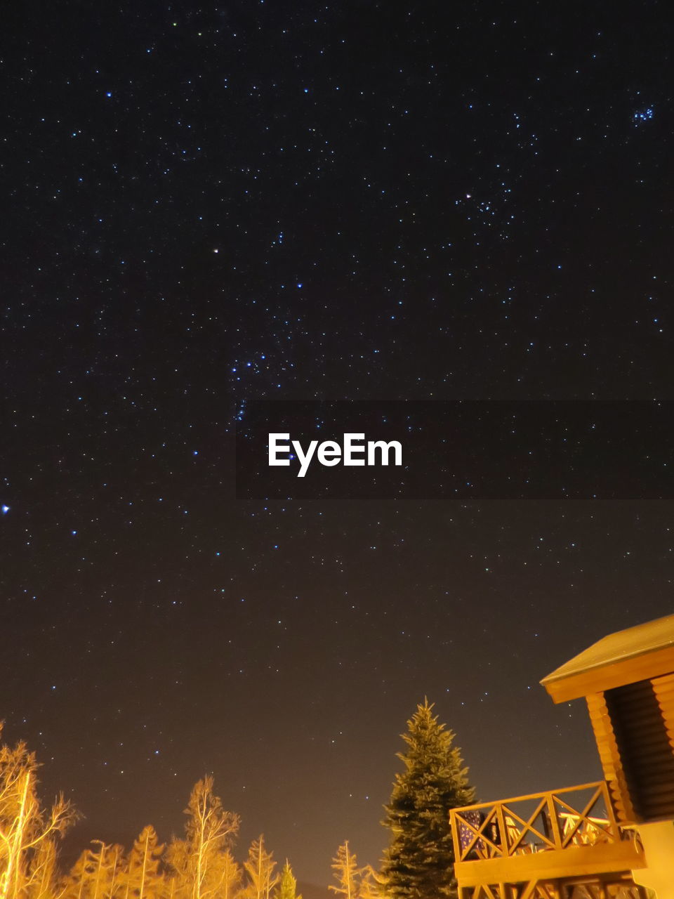 Low angle view of house against star field at night