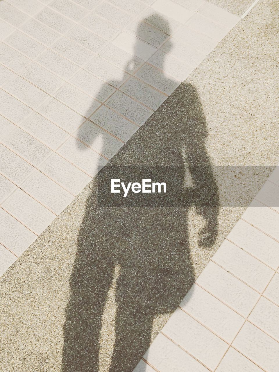 SHADOW OF PERSON ON STREET