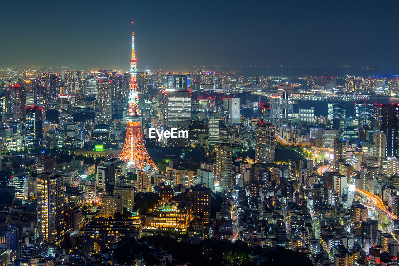 ILLUMINATED CITYSCAPE AGAINST SKY AT NIGHT