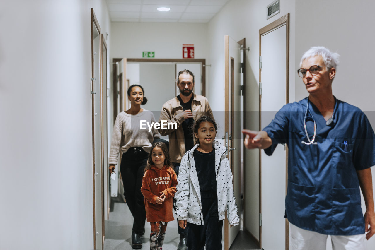 Female doctor with family in surgery