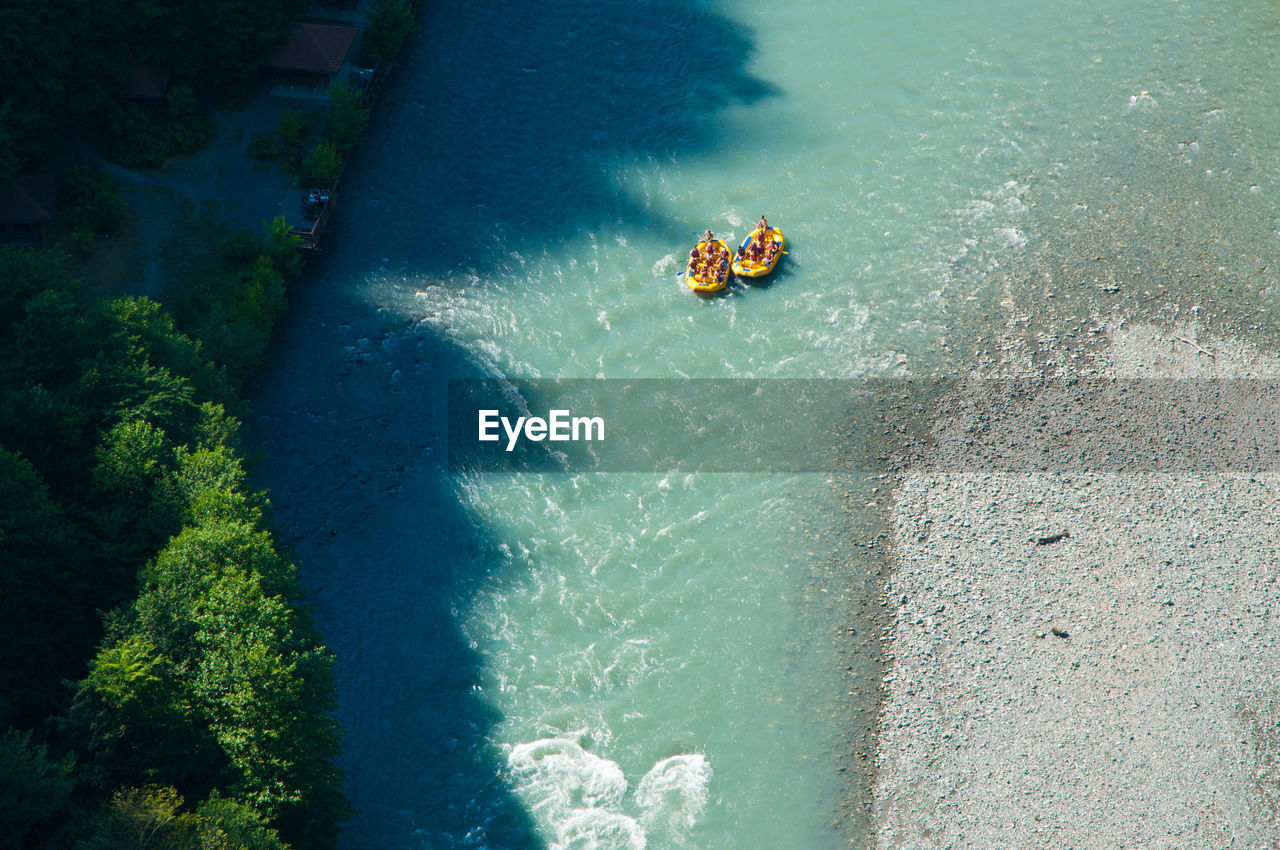 Aerial view of people sailing in river