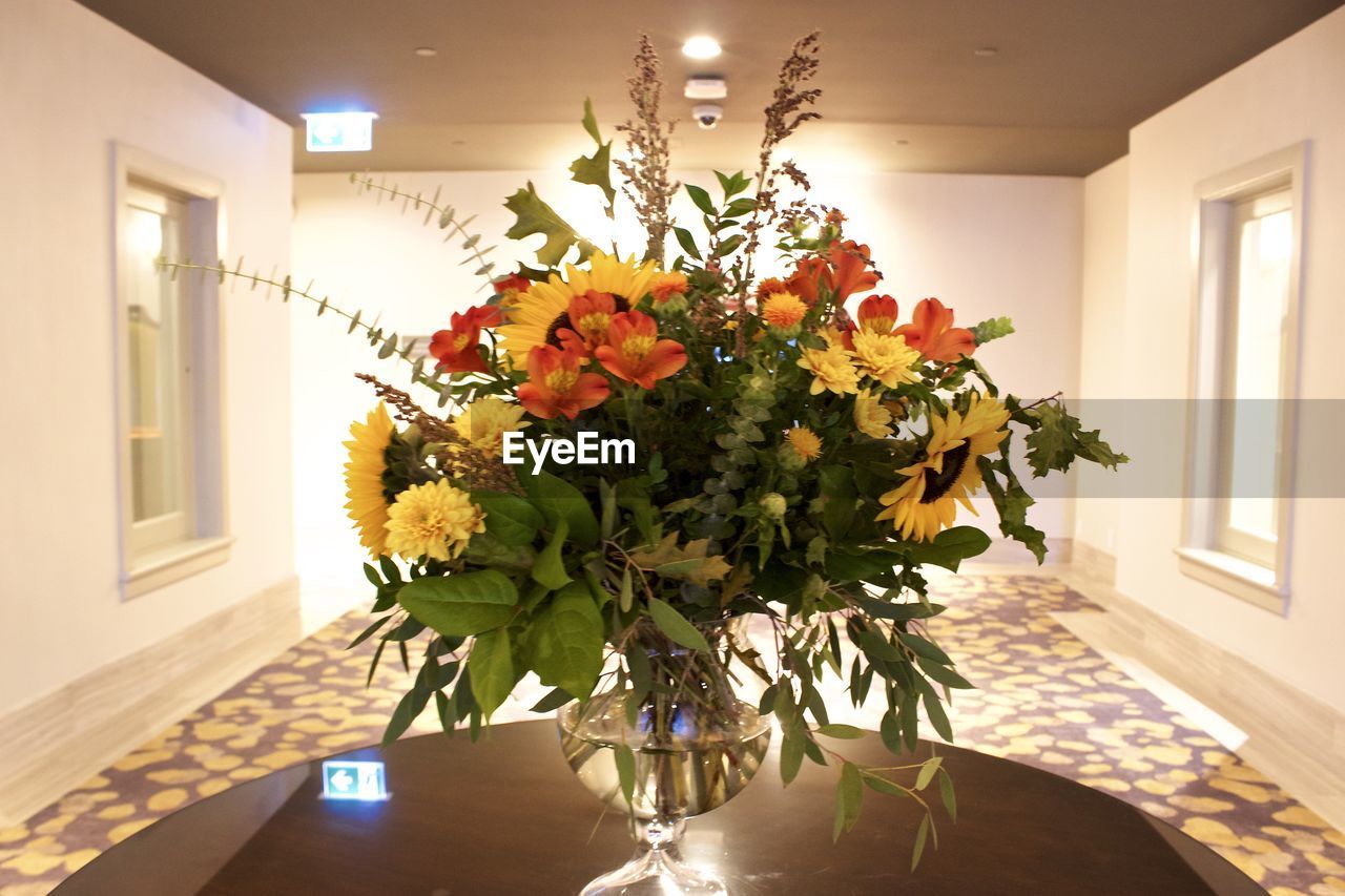 FLOWERS IN VASE ON TABLE