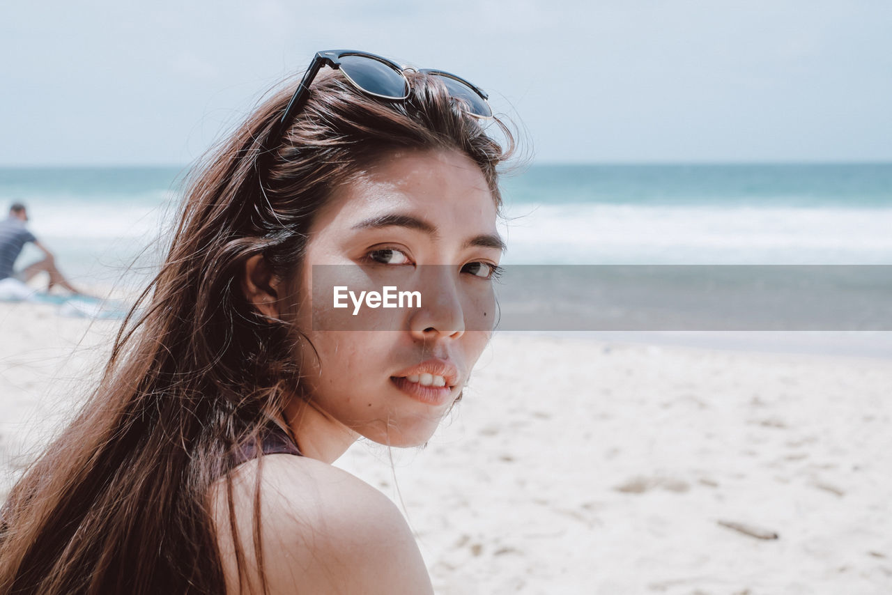 Portrait of mid adult woman standing at beach