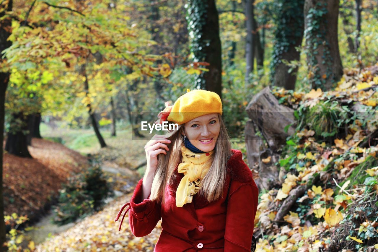 Portrait of a smiling young woman in forest