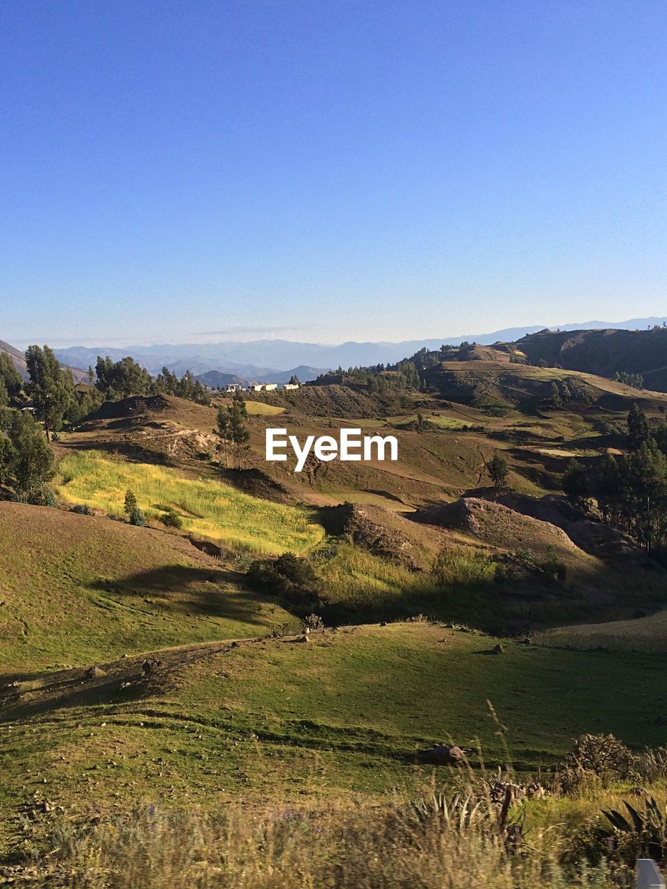 Scenic view of mountains against blue sky
