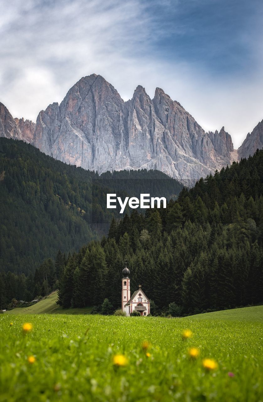 Scenic view of landscape and mountains against cloudy sky