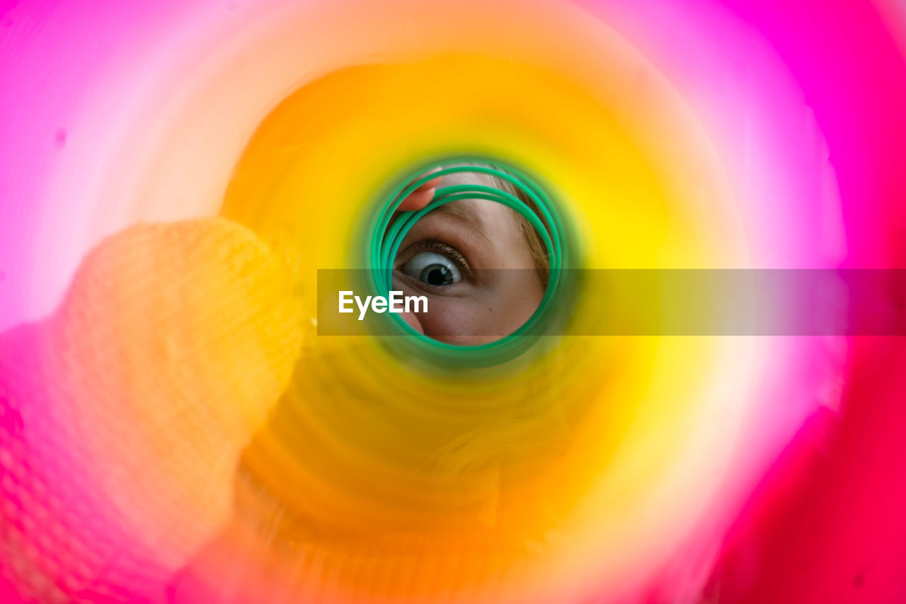 Child's eye through a colorful slinky