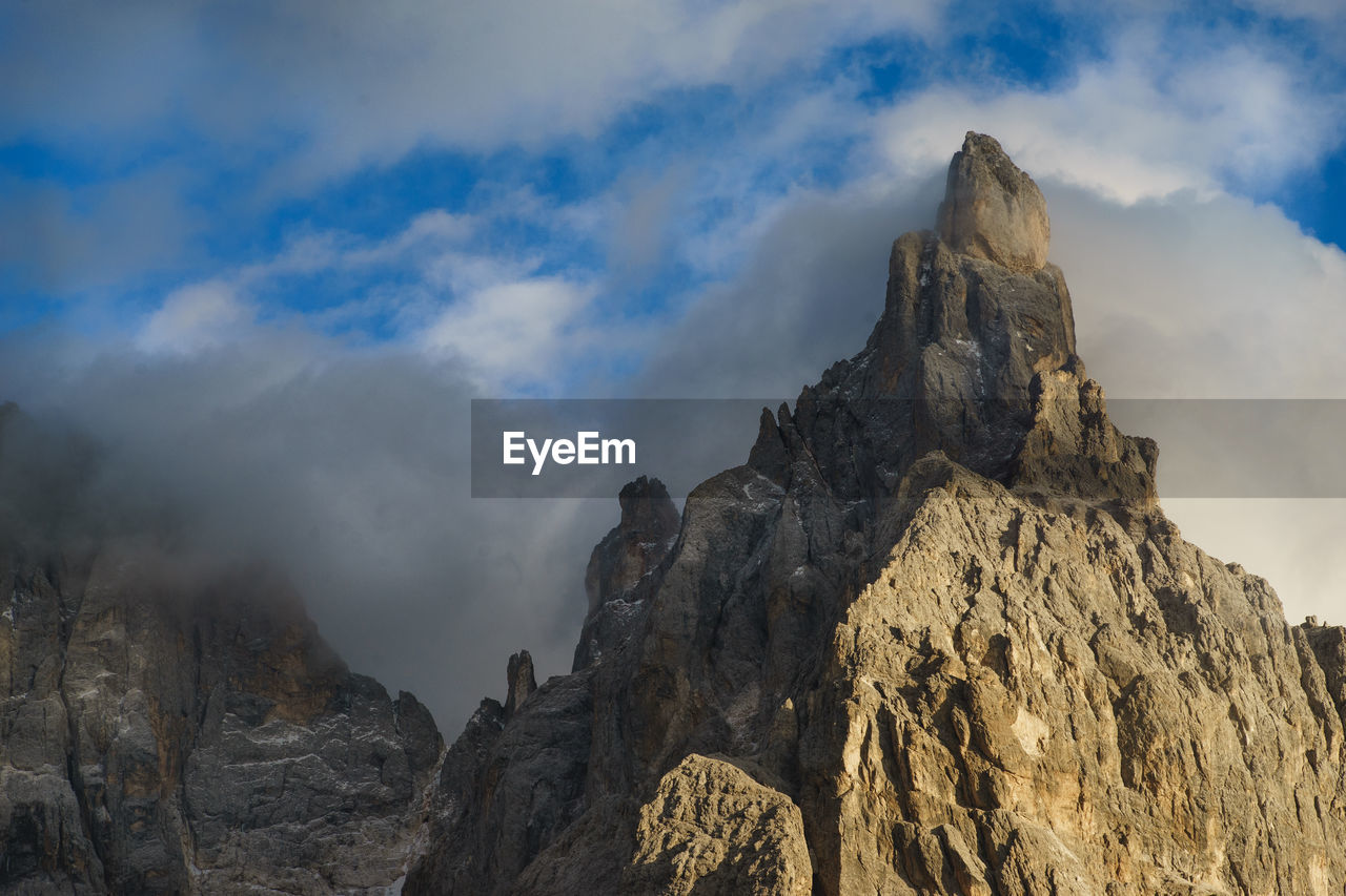 Low angle view of rock formation against sky