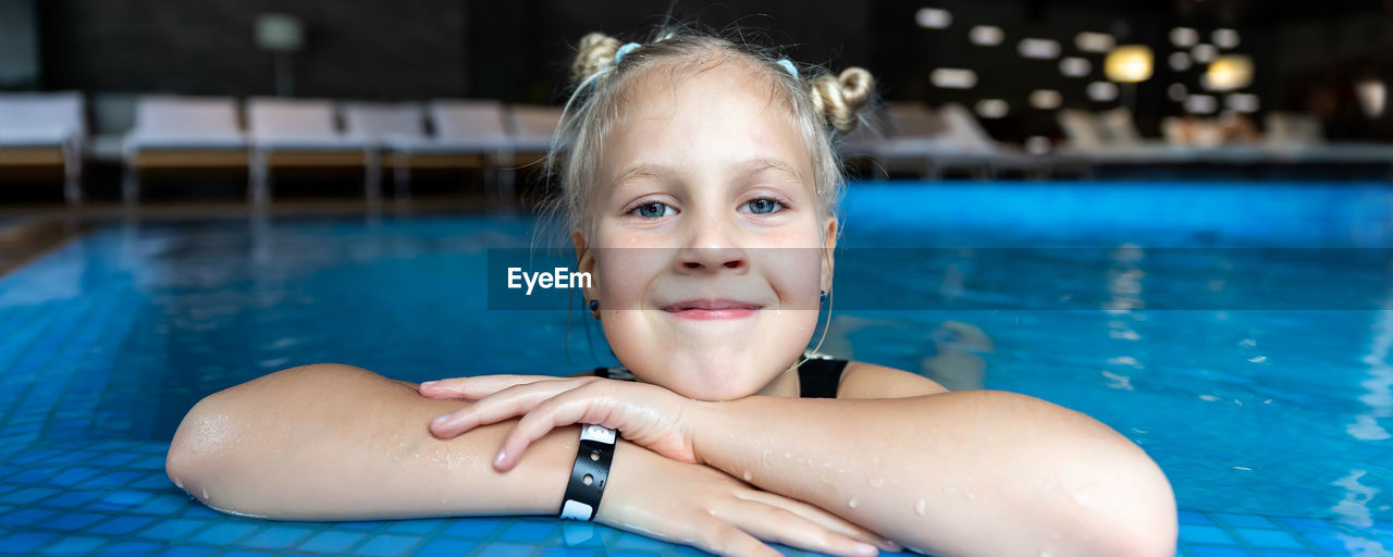 close-up portrait of young woman swimming in pool