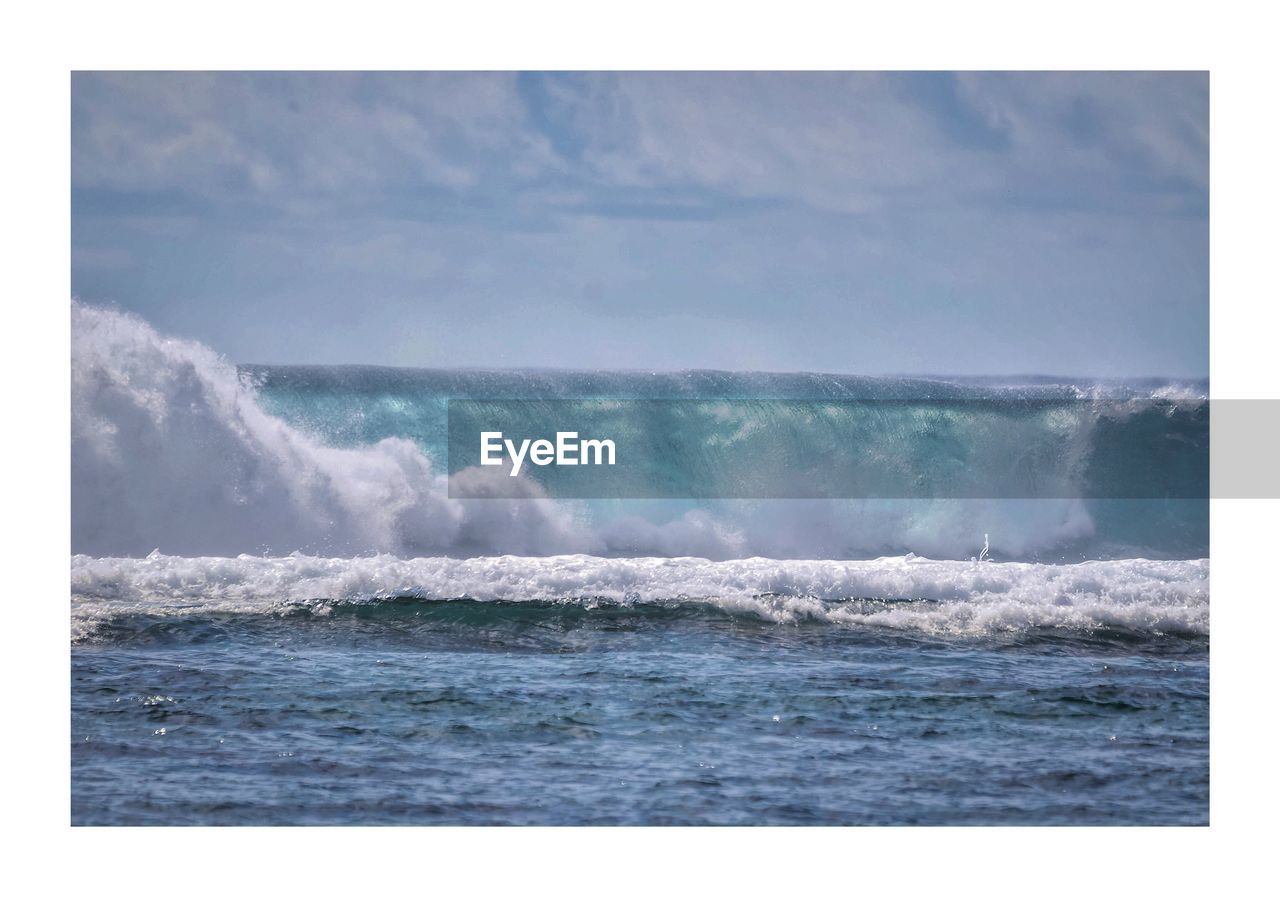 WAVES BREAKING AGAINST SEA