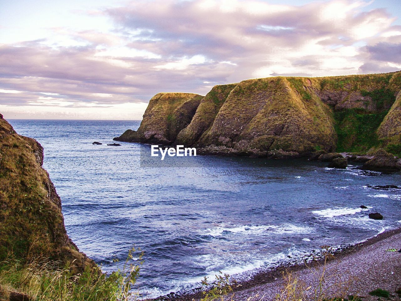 Scenic view of sea against cloudy sky