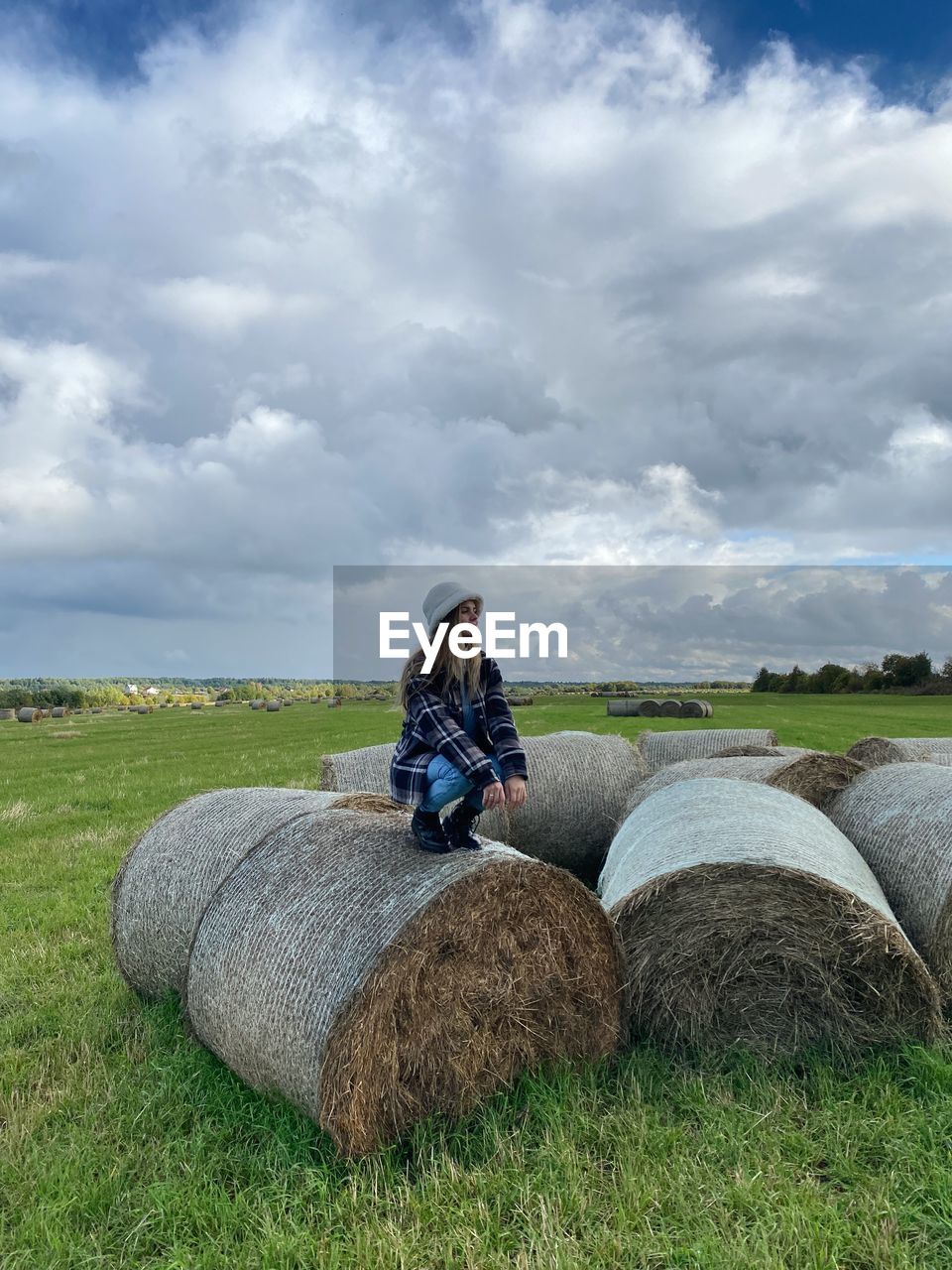 rear view of woman standing on hay