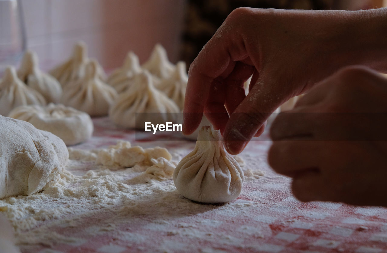 MIDSECTION OF PERSON PREPARING MEAT