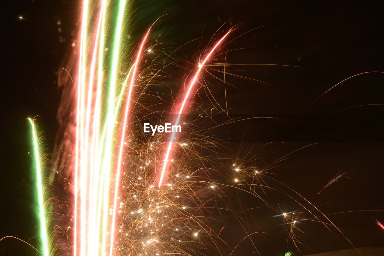 Low angle view of firework display against sky