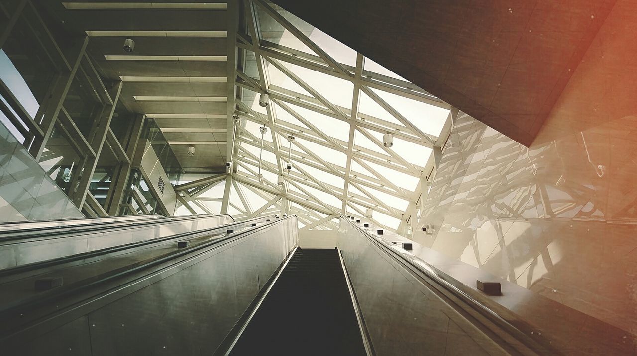 LOW ANGLE VIEW OF ESCALATOR IN SUNNY DAY