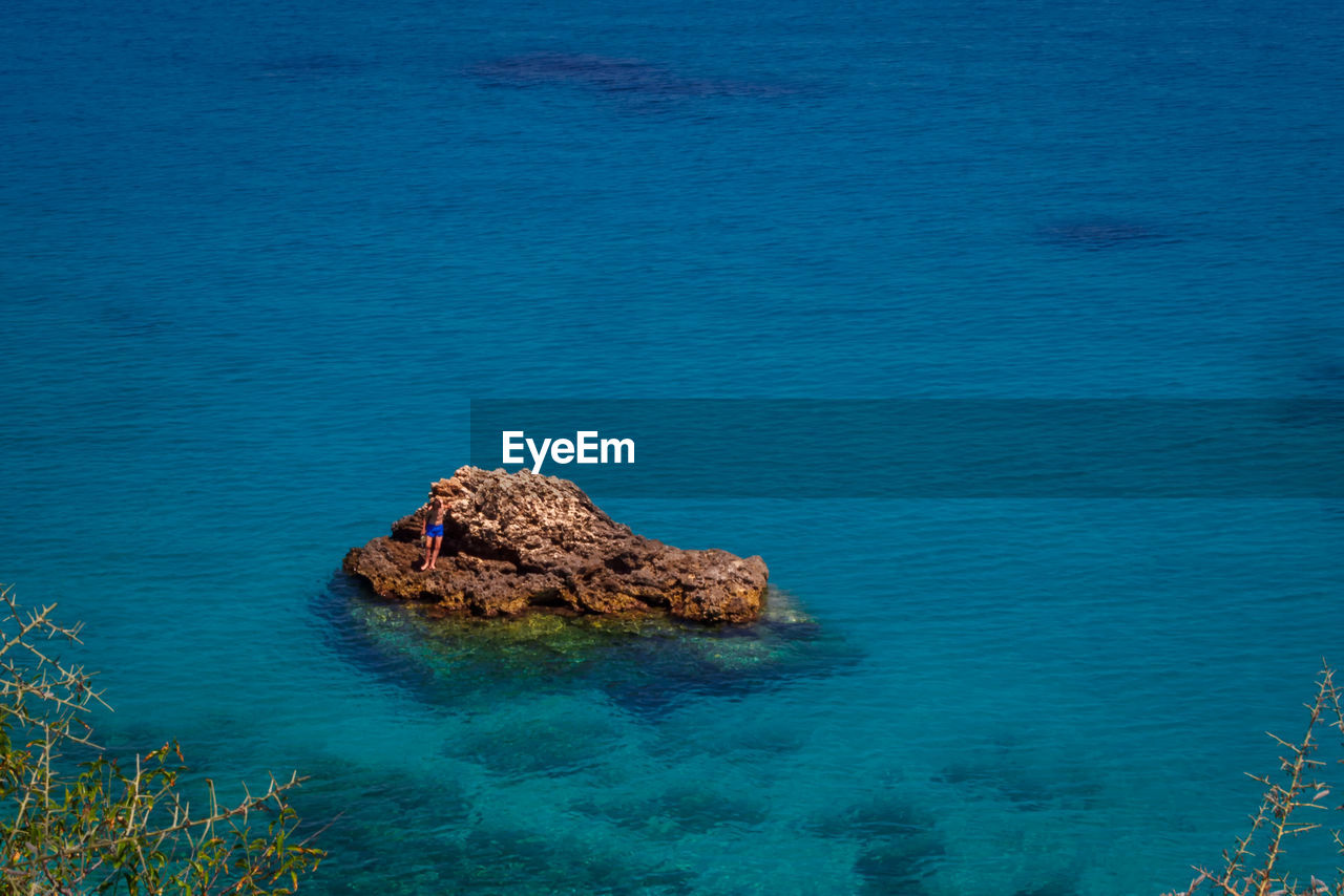 High angle view of rocks in sea