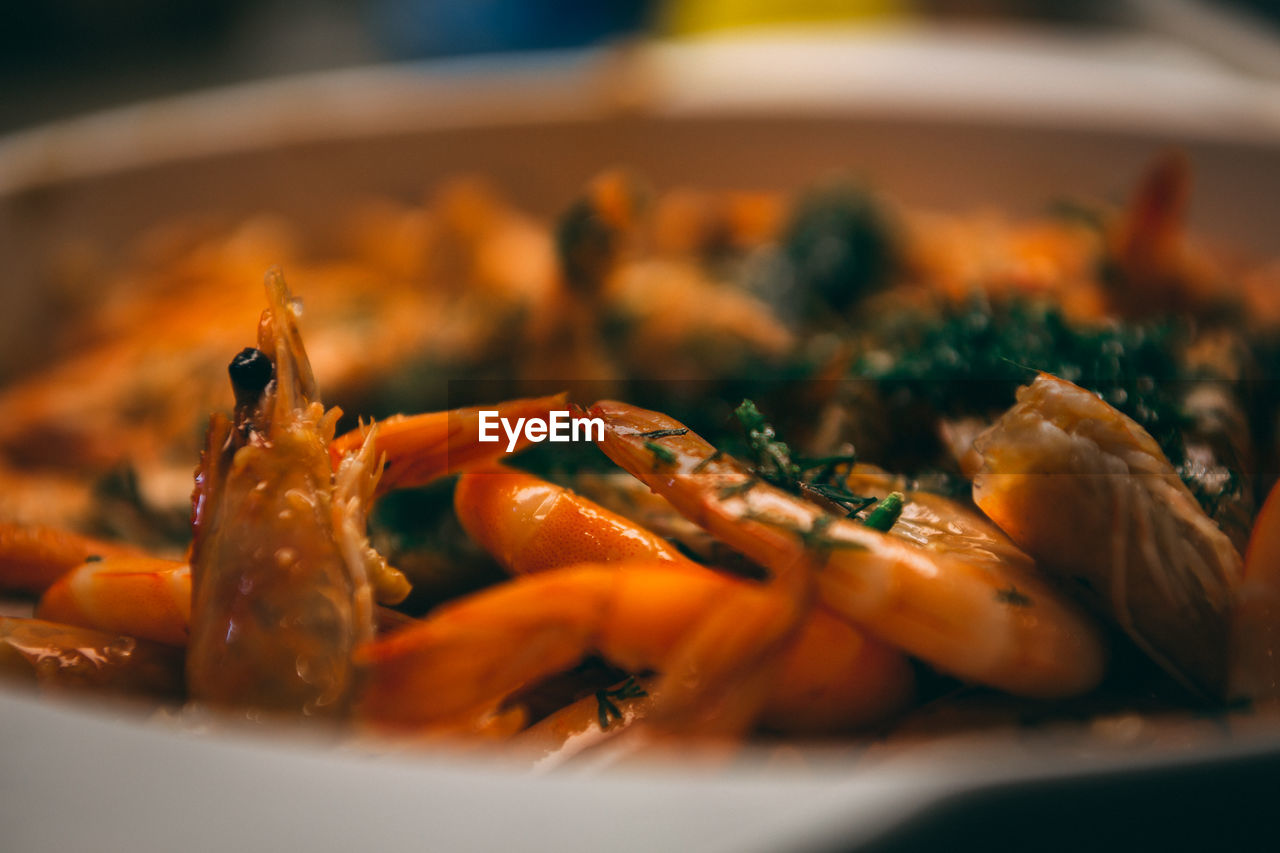 Fried until golden brown tiger shrimp are ready in a pan and serving at the table