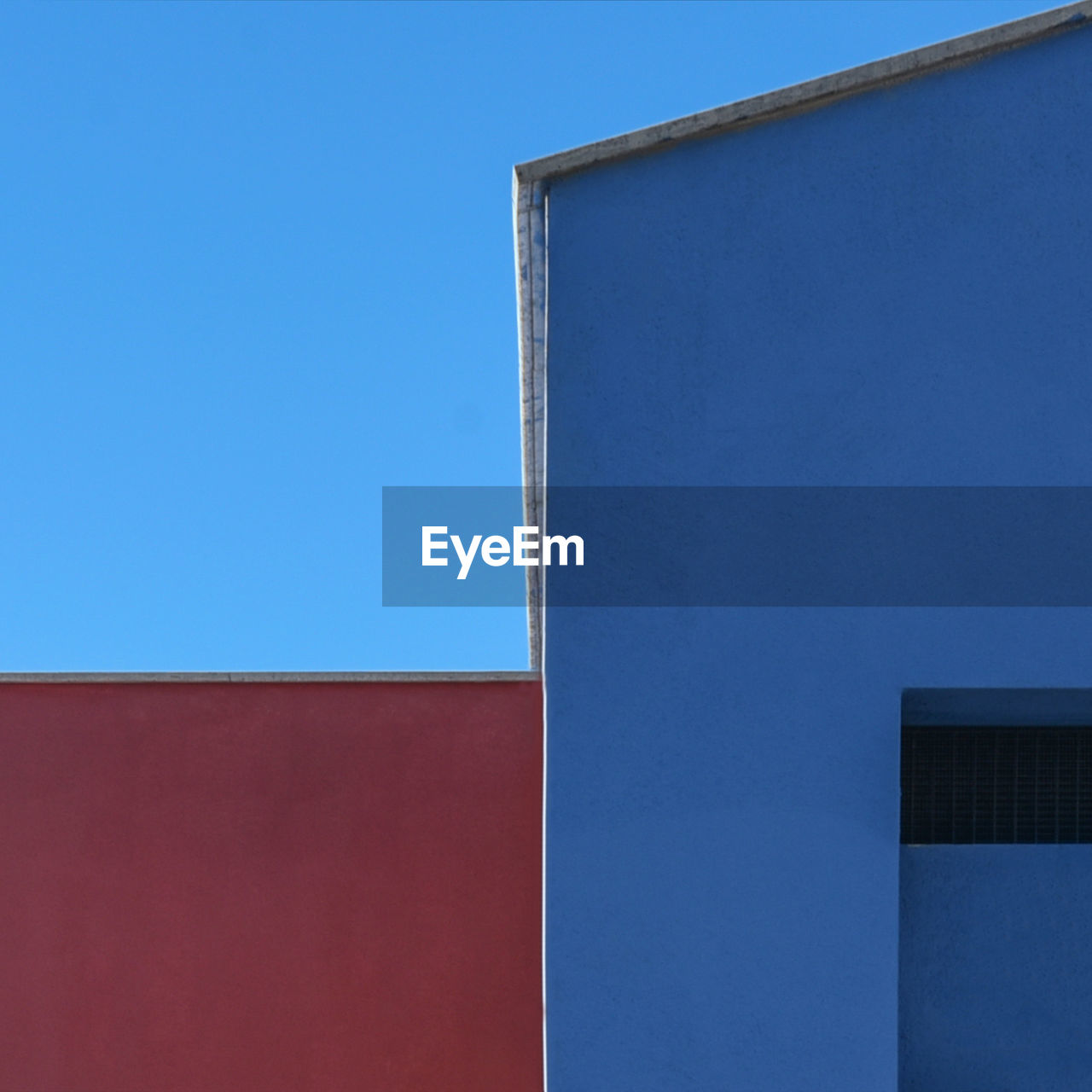 Low angle view of building against clear blue sky