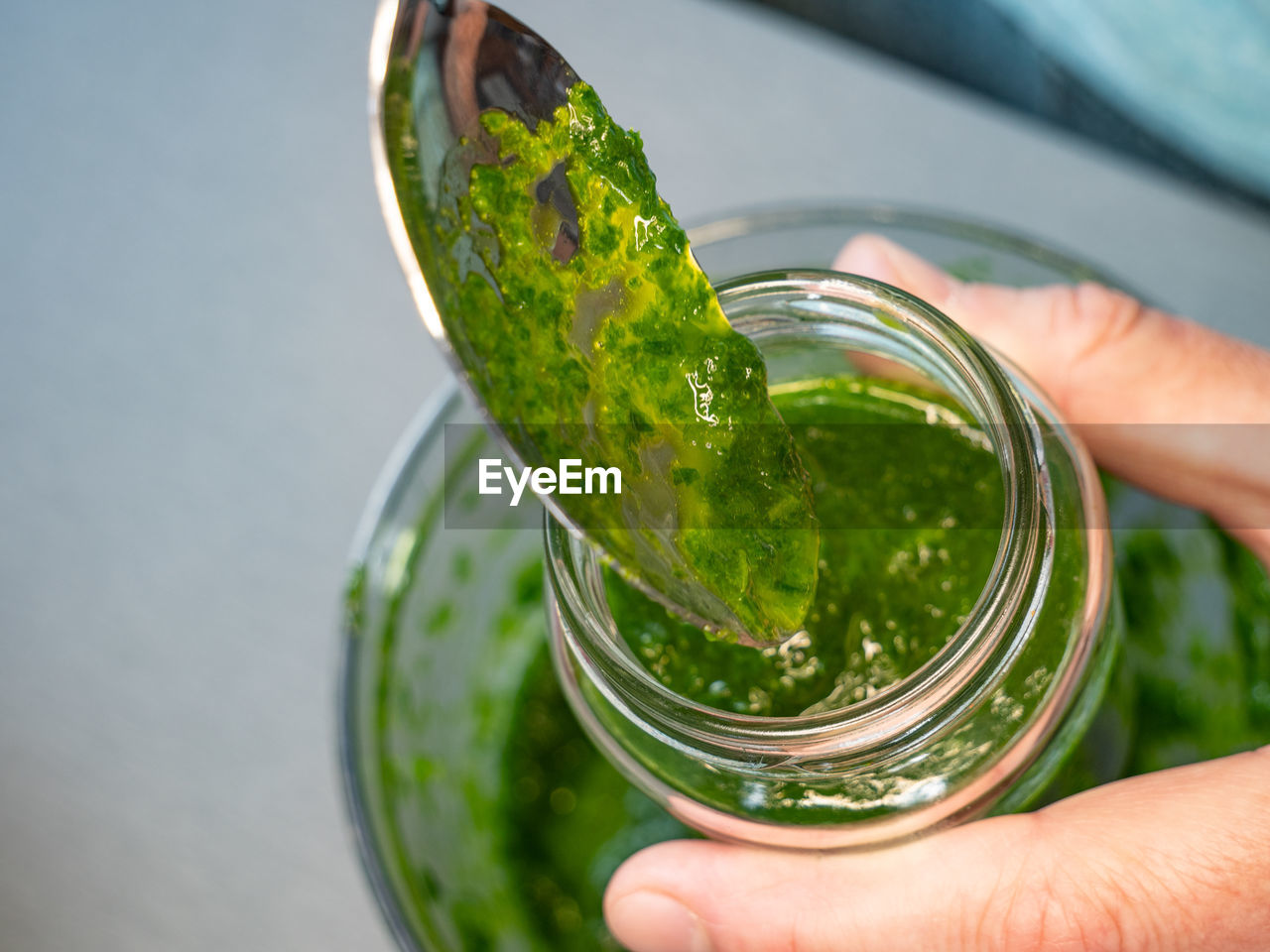 Home made traditional green chimichurri sauce with fresh parsley, wild garlic, olive oil in glass