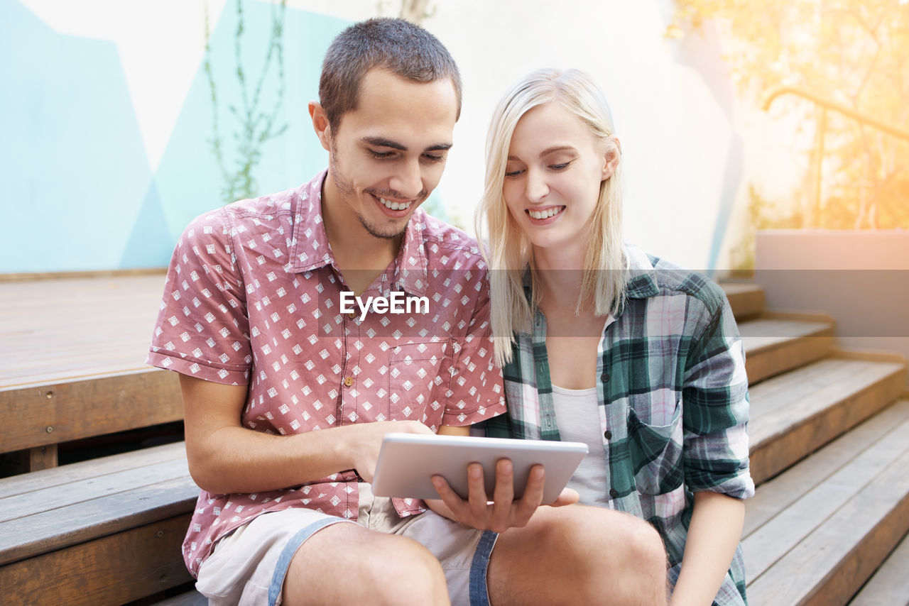 High angle view of couple using digital tablet