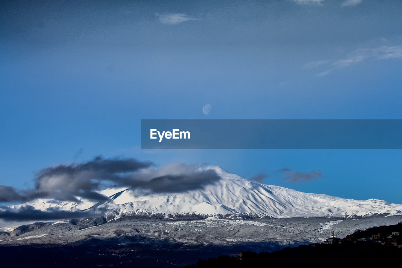 Scenic view of snowcapped mountains against sky