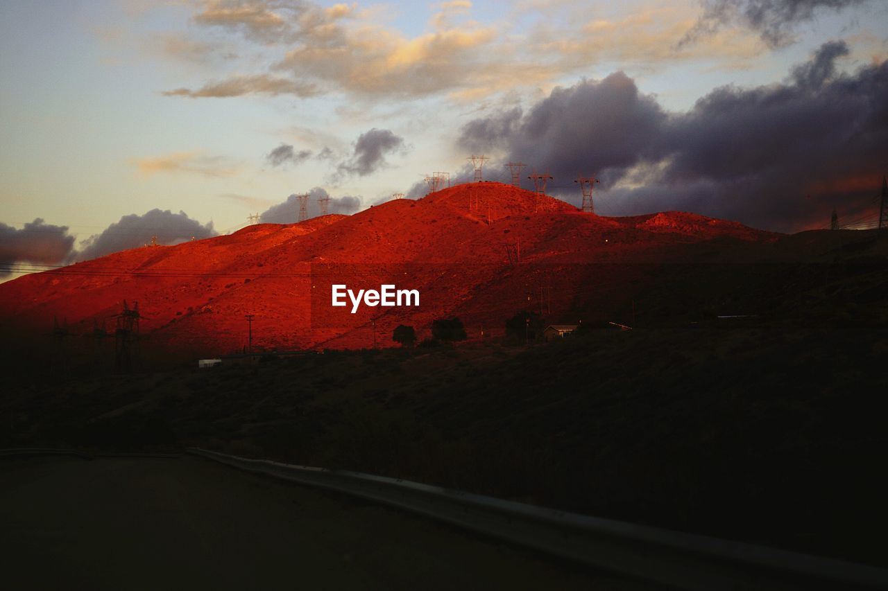 SCENIC VIEW OF MOUNTAINS AGAINST CLOUDY SKY