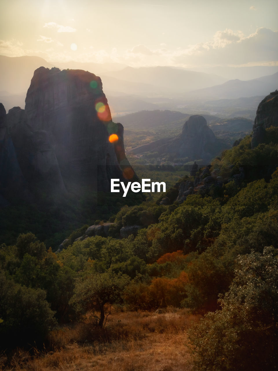 Tall, lonely rocks in a green valley and nostalgic nature. the great nature of greece, kalambaka 
