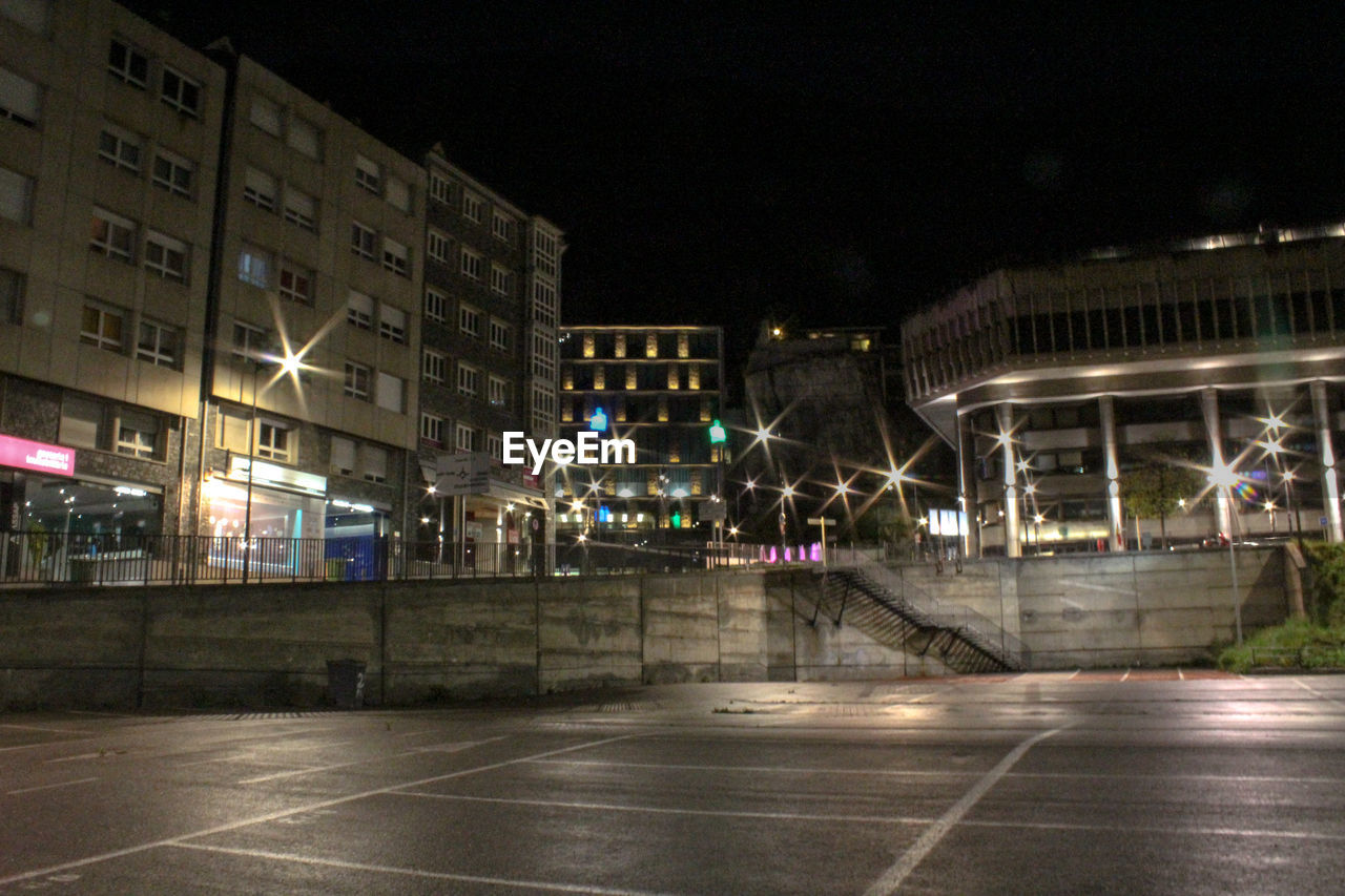 VIEW OF ILLUMINATED CITY AT NIGHT