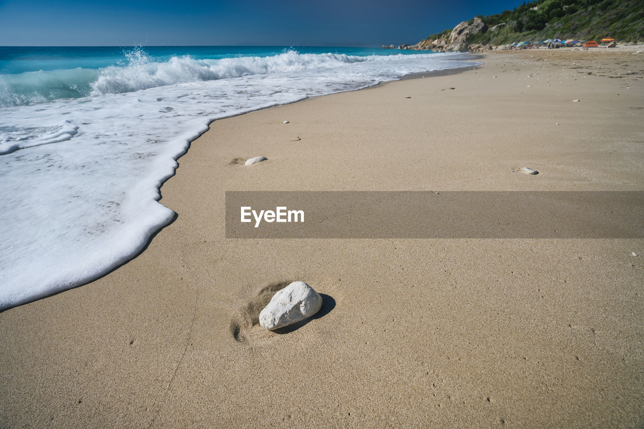 SCENIC VIEW OF WET SAND ON BEACH