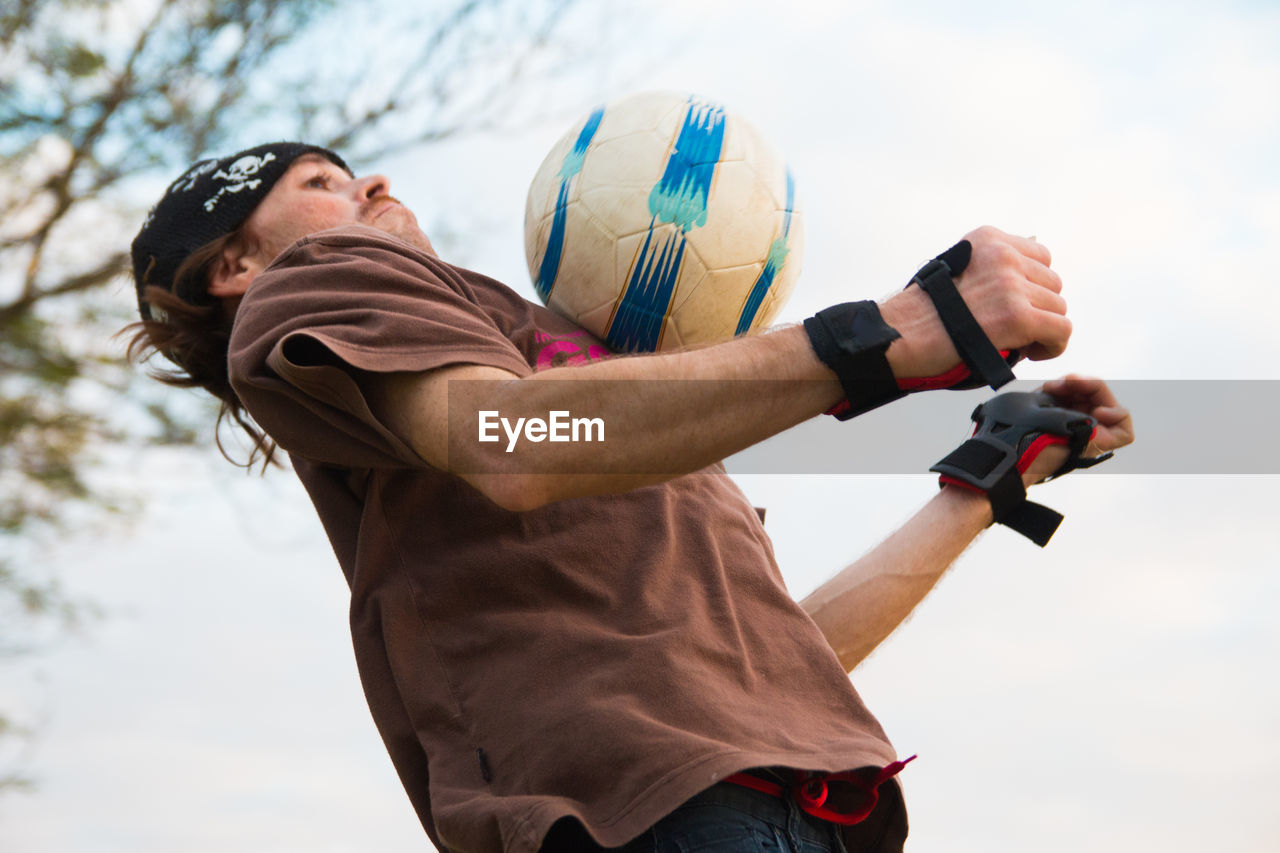 Man jumping to catch soccer ball