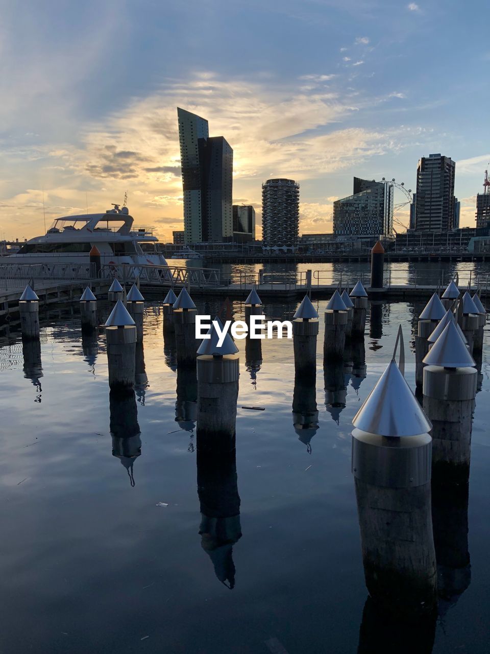 REFLECTION OF BUILDINGS IN RIVER AGAINST SKY