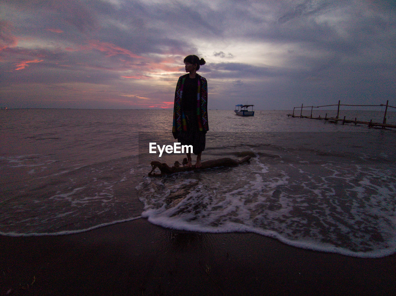 REAR VIEW OF BOY ON BEACH