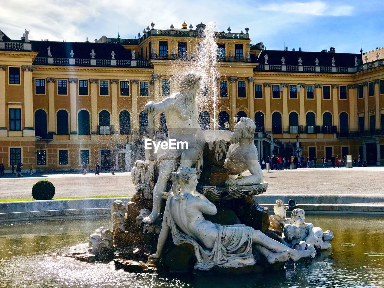 STATUE WITH FOUNTAIN IN FRONT OF BUILDING