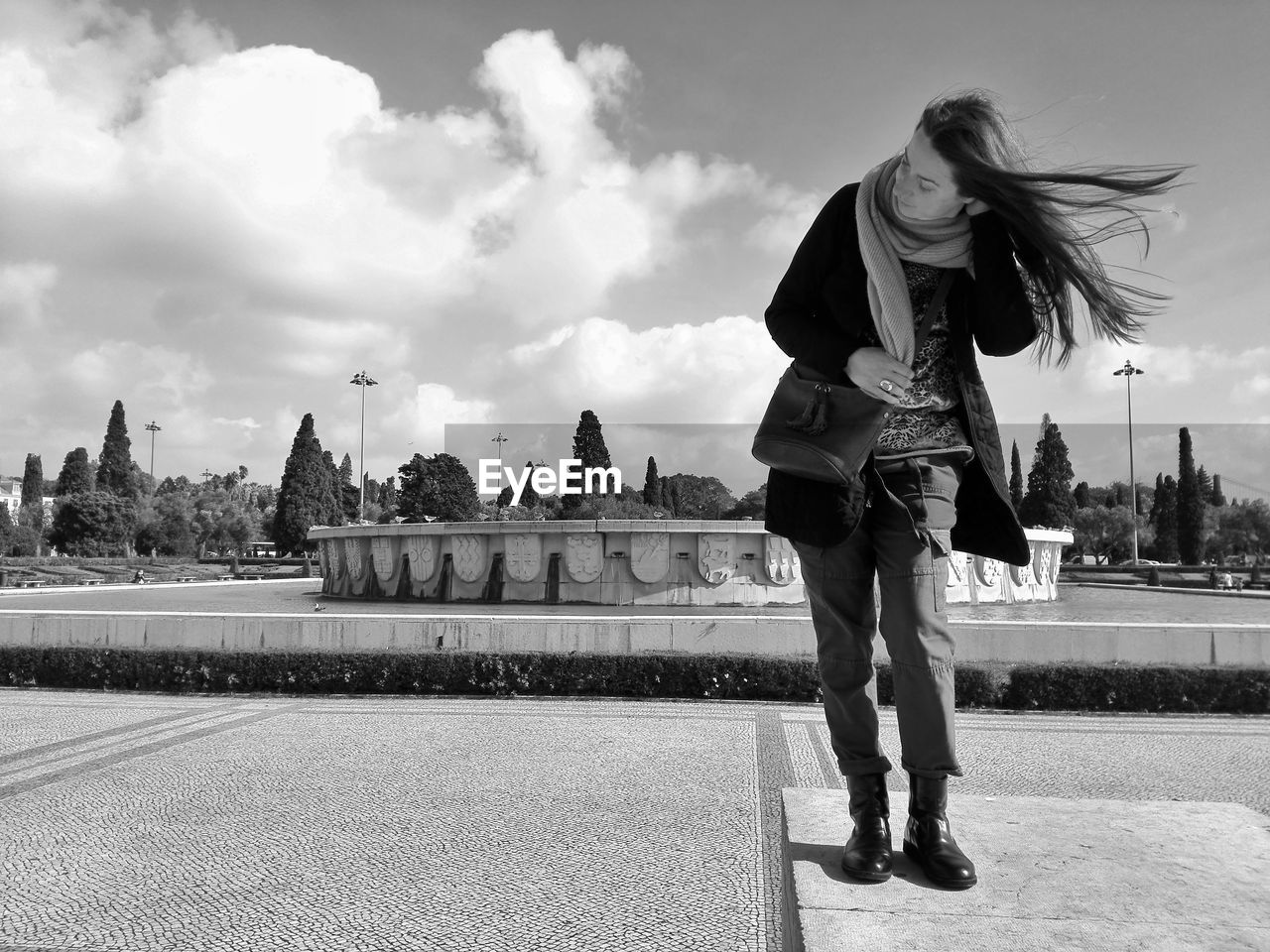 Full length of woman standing at park against sky