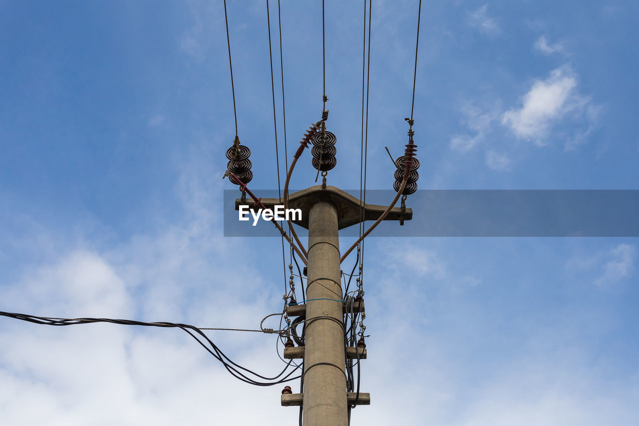low angle view of electricity pylon against blue sky