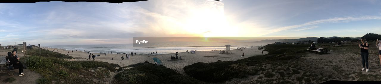 Panoramic view of beach against sky during sunset