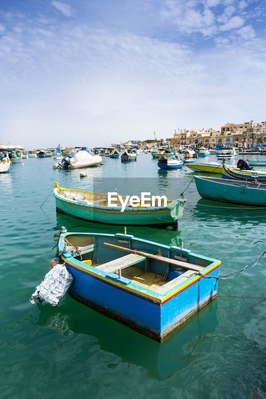 Boats moored in sea against sky