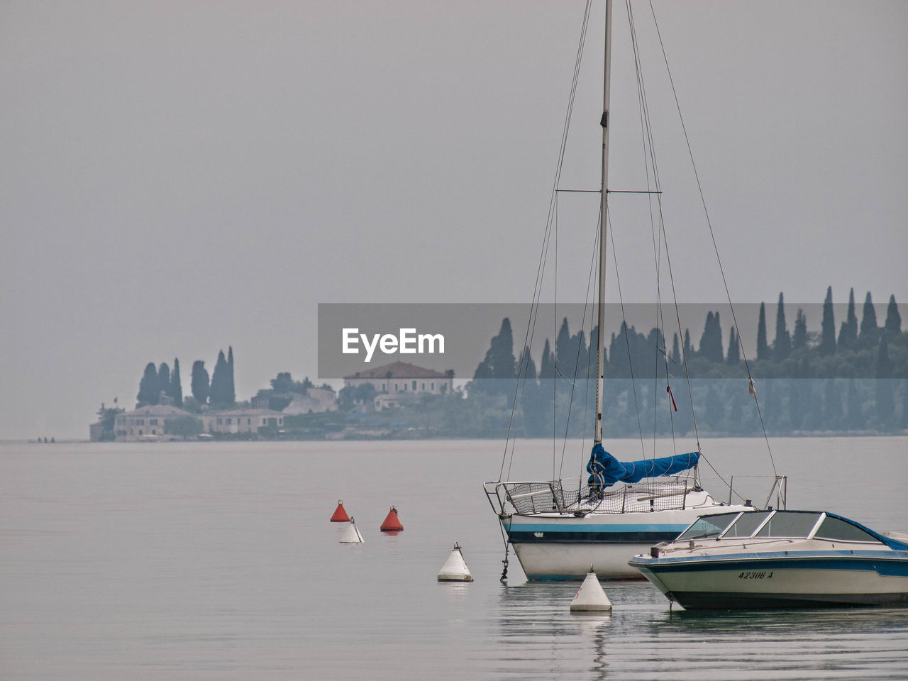 BOATS MOORED IN SEA