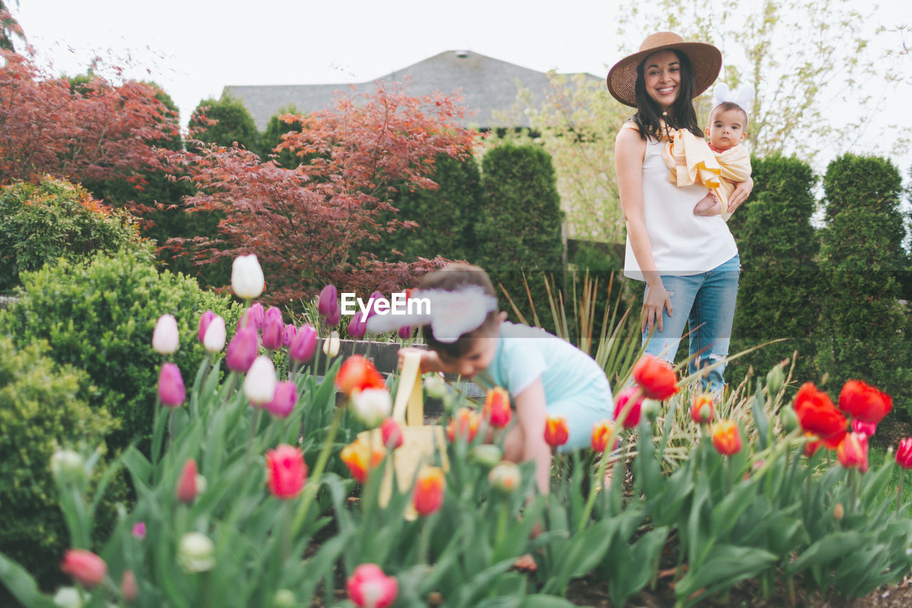 Smiling woman with children in garden