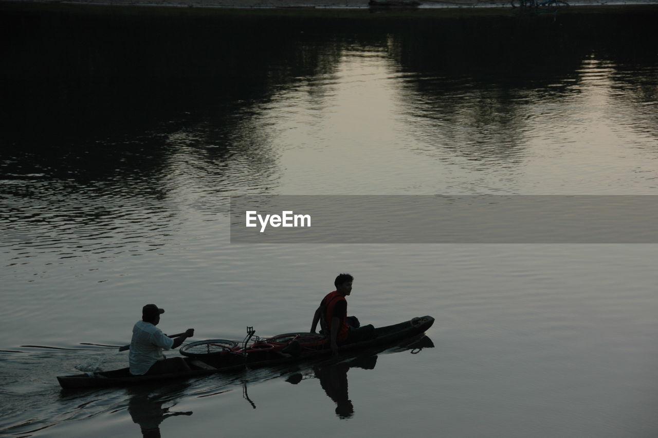 MAN SITTING IN LAKE