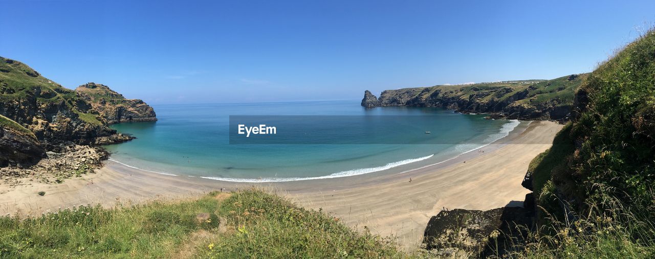 Scenic view of sea against clear blue sky