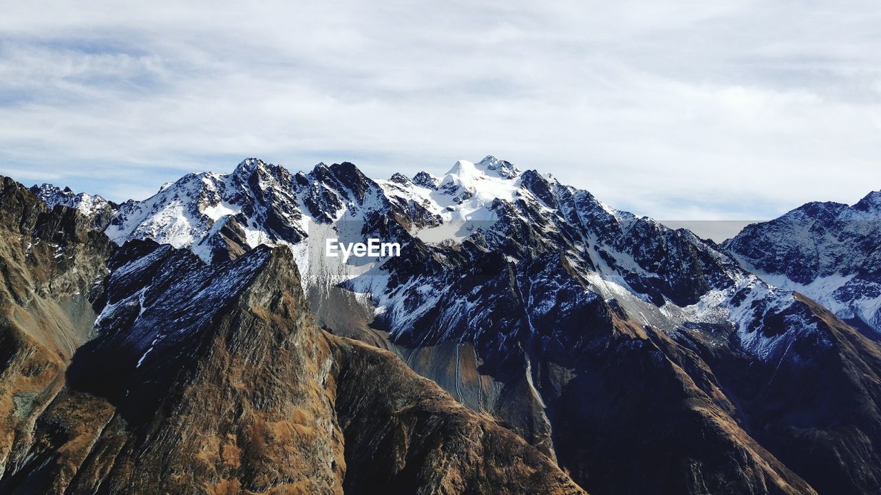 Scenic view of snowcapped mountains against sky