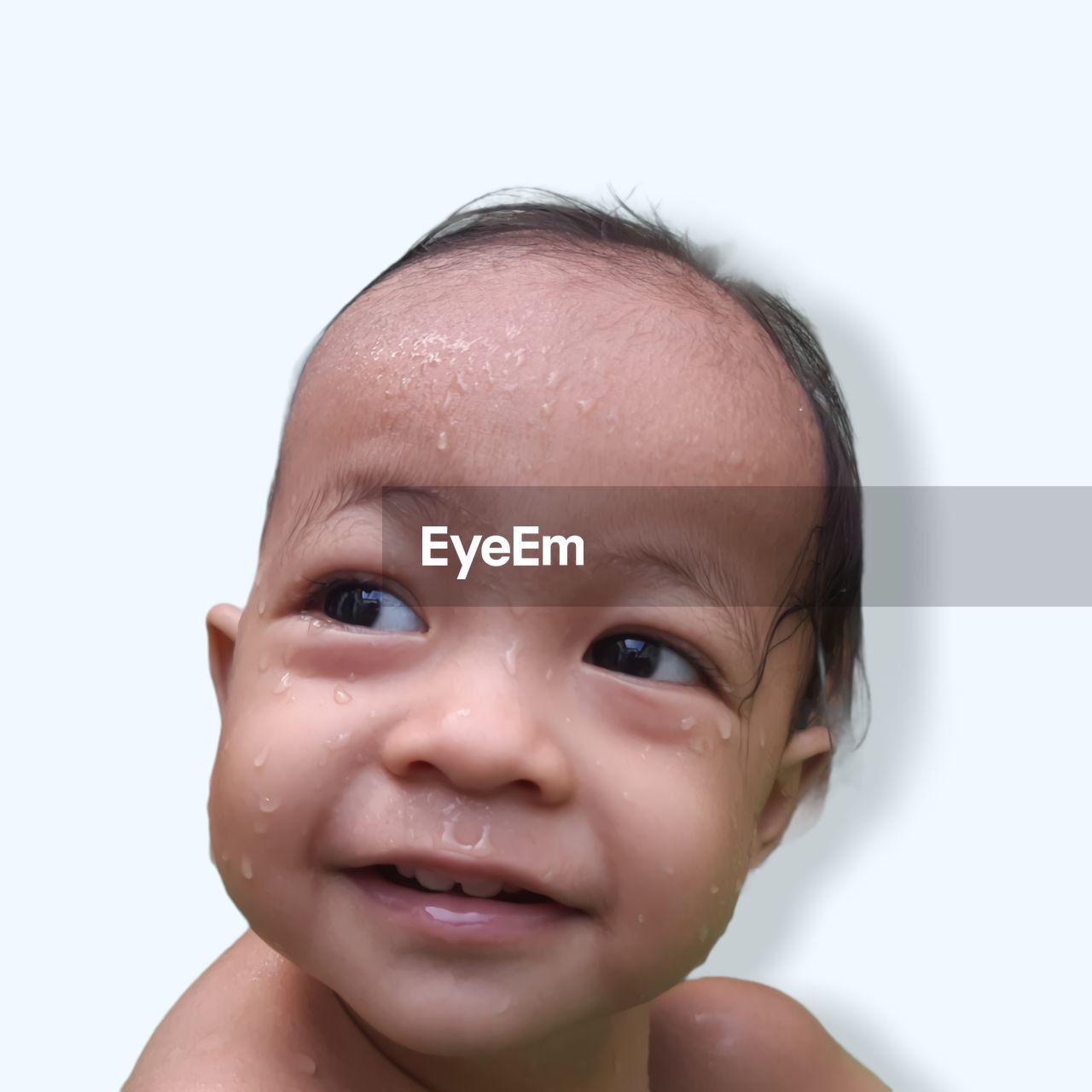 Portrait of cute baby boy against white background